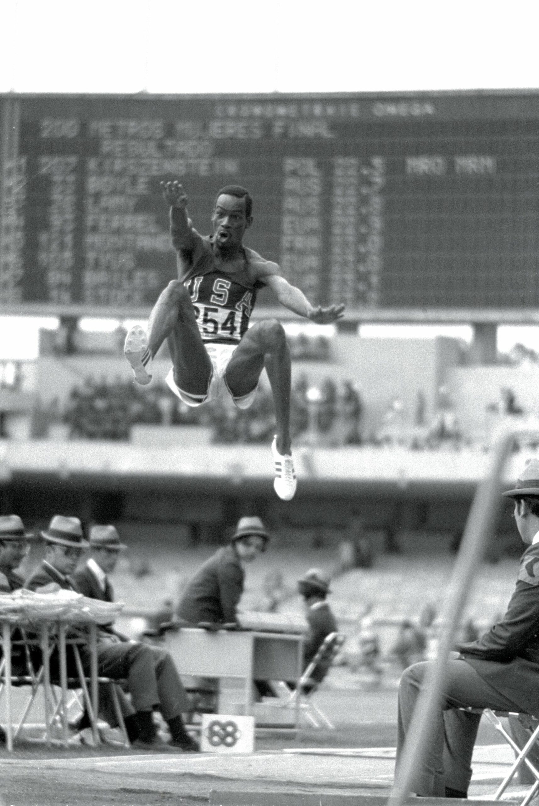 18 Oct 1968: Bob Beamon #254 of the USA breaking the Long Jump World Record during the 1968 Olympic Games in Mexico City, Mexico. Beamon long jumped 8.9 m (29 ft 2 1/2 in), winning the gold medal and setting a new world record. It is the first jump over 28 ft. The most famous long jump ever achieved: Bob Beamon of the United States takes off for a place in sporting history as he leaps 8.90 metres at the Mexico City Games of 1968. While the middle distance runners from the low level countries floundered in the thin air of Mexico City, those in the explosive events reached new peaks, none higher than Beamon, who added 58 centimetres to the world record with a jump aided by a wind of 2 metres per second the very limit of wind assistance. In Imperial measure terms it looked even more impressive since he missed out 28 feet, taking the record to 29 ft 2 ins. Yet Beamon never again managed a jump of 27 feet. It was twelve years before anyone else reached 28 feet (8.53 metres) and the record stood until 1991 when Mike Powell of the US leapt 8.95 metres in Tokyo to win the world title. His jump was at sea level and wind assistance of 0.3mps. Mandatory Credit: Tony Duffy /Allsport